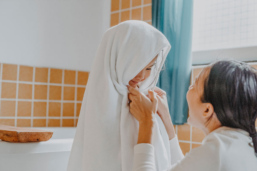 little girl done taking a kids detox bath for heavy metals with mom in towel