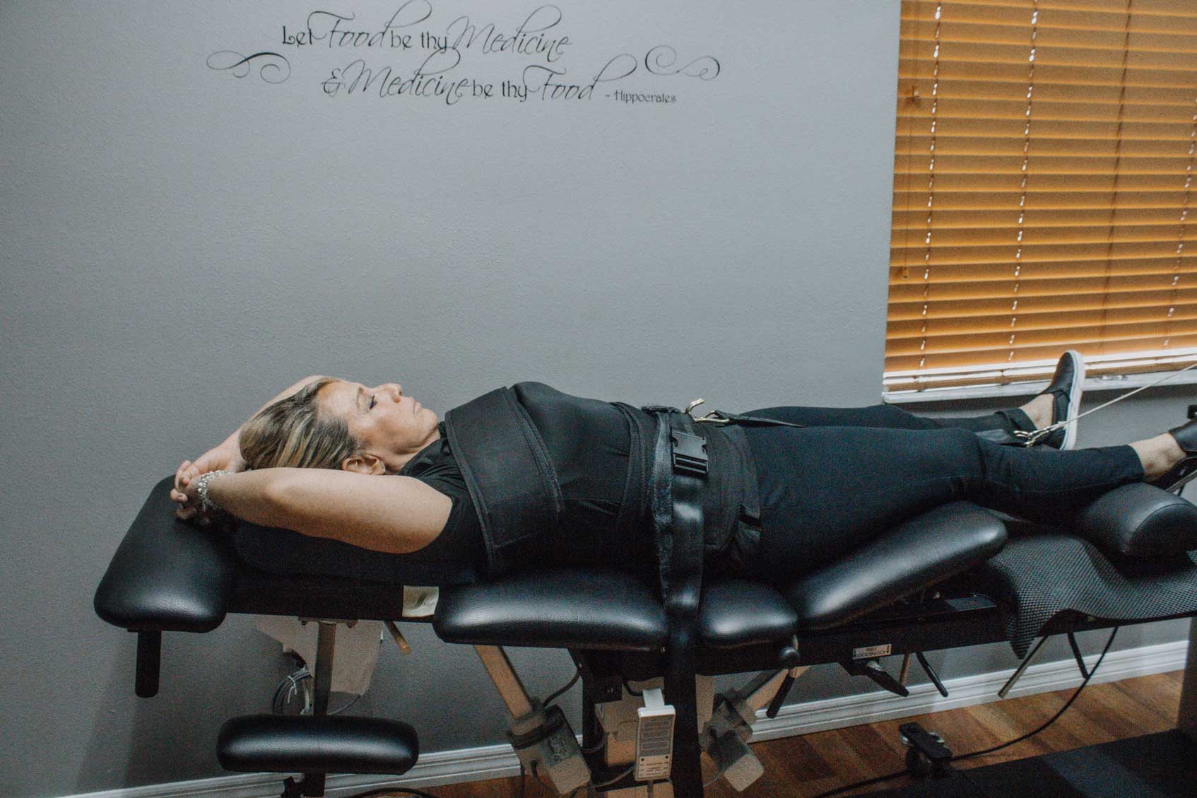 spinal decompression table with female patient lying on back